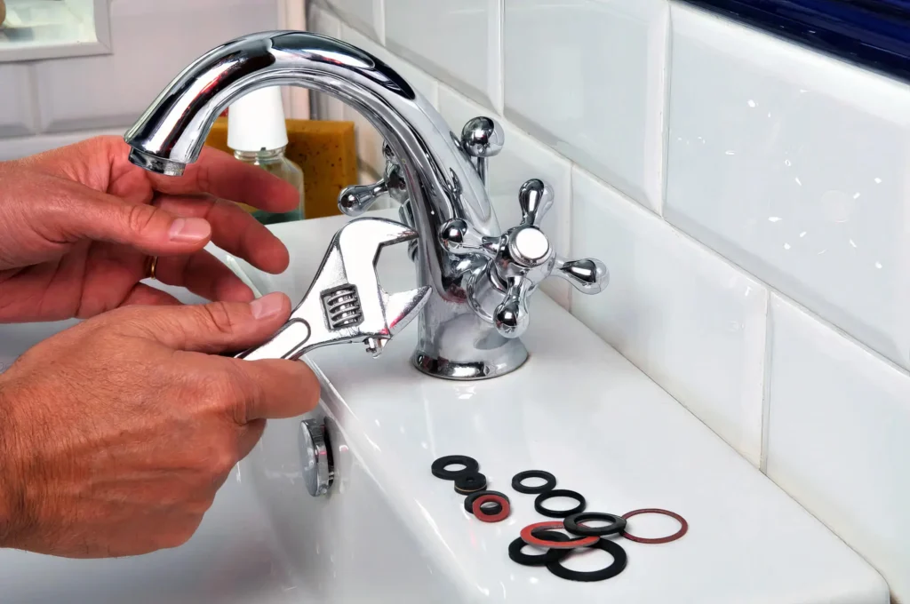 Plumber performing maintenance on a bathroom faucet in Kissimmee