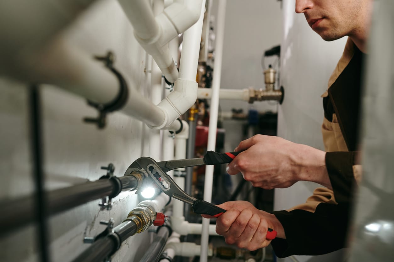 Plumbers maintaining commercial plumbing pipes in Kissimmee