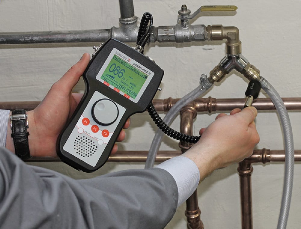 Plumber testing pipes with electronic leak detection equipment in Kissimmee