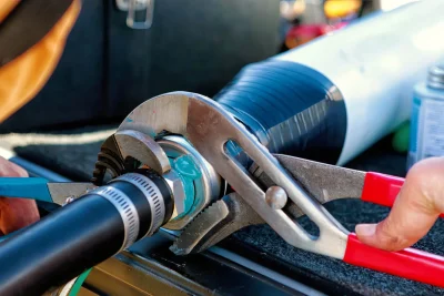 Technician tightening an industrial pipe connection in Kissimmee