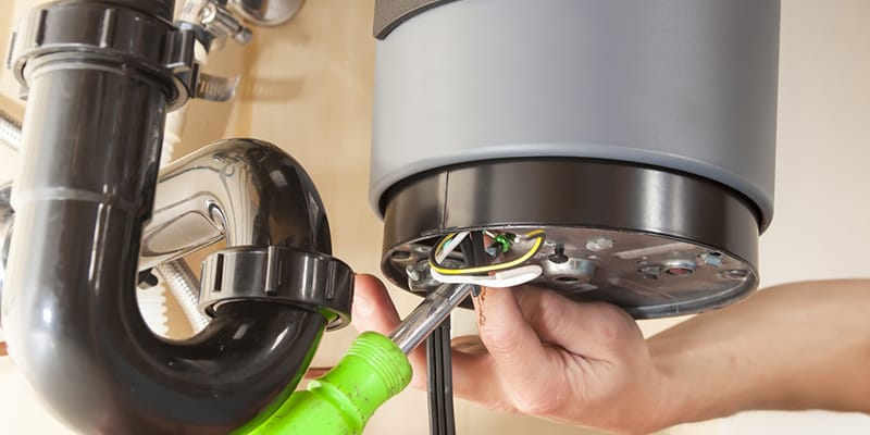 Technician repairing the heating element of a water heater in Kissimmee
