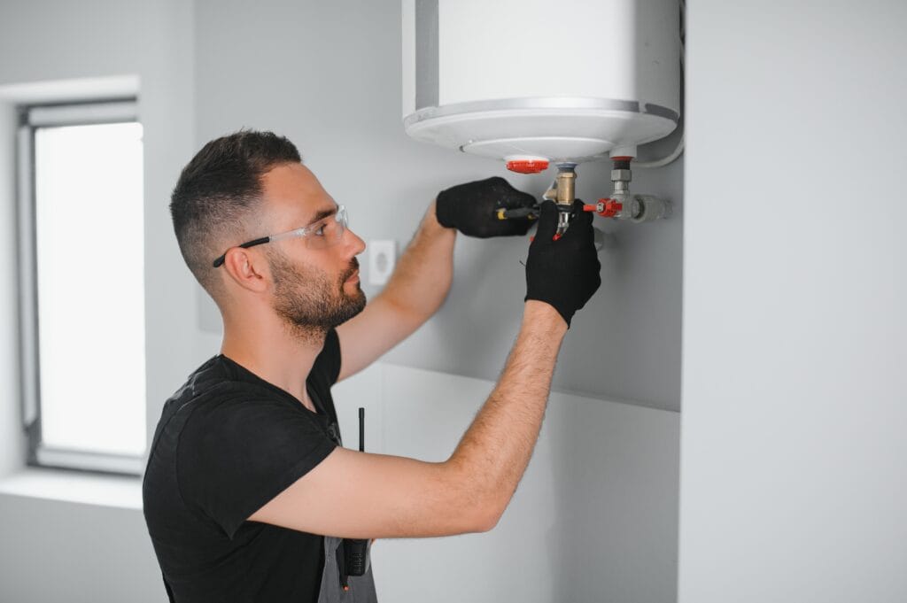 Technician performing water heater maintenance in Kissimmee