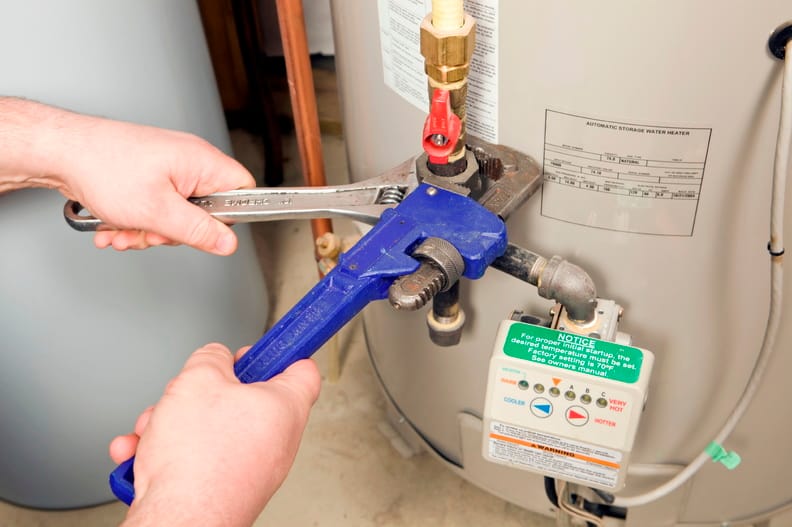 Plumber repairing a water heater valve in Kissimmee